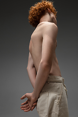 Image showing Portrait of beautiful redhead man isolated on grey studio background. Concept of beauty, skin care, fashion and style