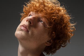 Image showing Portrait of beautiful redhead man isolated on grey studio background. Concept of beauty, skin care, fashion and style