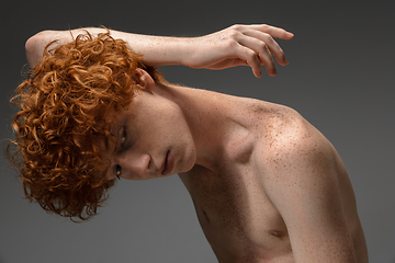 Image showing Portrait of beautiful redhead man isolated on grey studio background. Concept of beauty, skin care, fashion and style