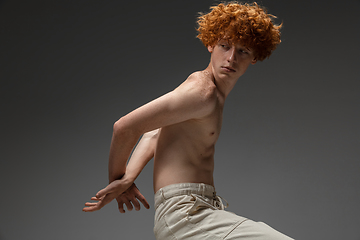 Image showing Portrait of beautiful redhead man isolated on grey studio background. Concept of beauty, skin care, fashion and style