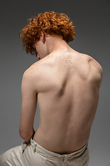 Image showing Portrait of beautiful redhead man isolated on grey studio background. Concept of beauty, skin care, fashion and style