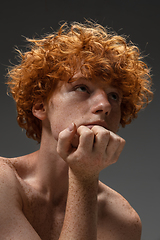 Image showing Portrait of beautiful redhead man isolated on grey studio background. Concept of beauty, skin care, fashion and style