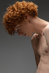 Image showing Portrait of beautiful redhead man isolated on grey studio background. Concept of beauty, skin care, fashion and style