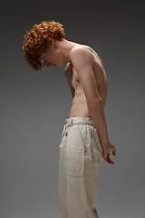 Image showing Portrait of beautiful redhead man isolated on grey studio background. Concept of beauty, skin care, fashion and style