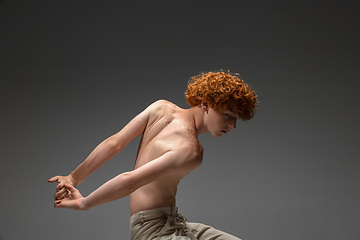 Image showing Portrait of beautiful redhead man isolated on grey studio background. Concept of beauty, skin care, fashion and style