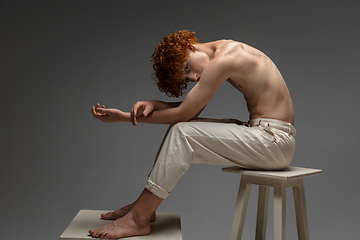 Image showing Portrait of beautiful redhead man isolated on grey studio background. Concept of beauty, skin care, fashion and style