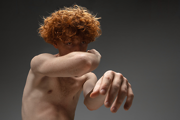 Image showing Portrait of beautiful redhead man isolated on grey studio background. Concept of beauty, skin care, fashion and style