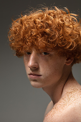 Image showing Portrait of beautiful redhead man isolated on grey studio background. Concept of beauty, skin care, fashion and style