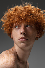 Image showing Portrait of beautiful redhead man isolated on grey studio background. Concept of beauty, skin care, fashion and style