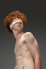 Image showing Portrait of beautiful redhead man isolated on grey studio background. Concept of beauty, skin care, fashion and style