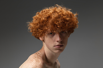 Image showing Portrait of beautiful redhead man isolated on grey studio background. Concept of beauty, skin care, fashion and style