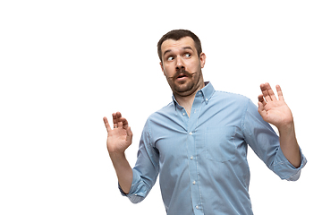 Image showing Young caucasian man with funny, unusual popular emotions and gestures isolated on white studio background