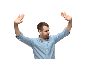 Image showing Young caucasian man with funny, unusual popular emotions and gestures isolated on white studio background