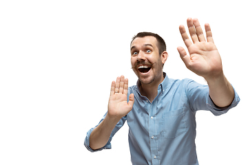 Image showing Young caucasian man with funny, unusual popular emotions and gestures isolated on white studio background