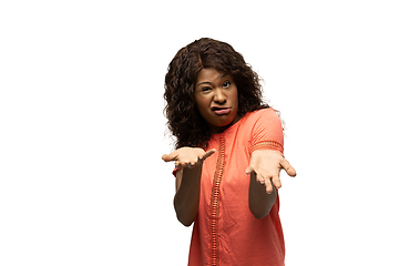 Image showing Young african-american woman with funny, unusual popular emotions and gestures isolated on white studio background