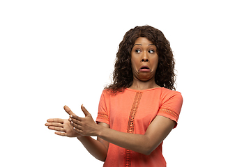 Image showing Young african-american woman with funny, unusual popular emotions and gestures isolated on white studio background