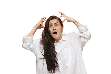 Image showing Young caucasian woman with funny, unusual popular emotions and gestures isolated on white studio background