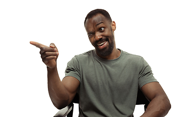 Image showing Young african-american man with funny, unusual popular emotions and gestures isolated on white studio background