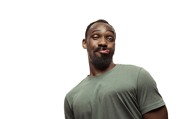 Image showing Young african-american man with funny, unusual popular emotions and gestures isolated on white studio background