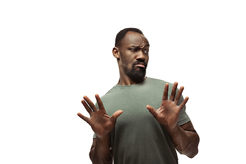 Image showing Young african-american man with funny, unusual popular emotions and gestures isolated on white studio background