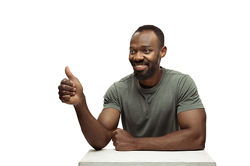 Image showing Young african-american man with funny, unusual popular emotions and gestures isolated on white studio background