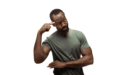 Image showing Young african-american man with funny, unusual popular emotions and gestures isolated on white studio background