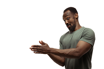 Image showing Young african-american man with funny, unusual popular emotions and gestures isolated on white studio background