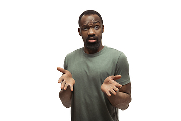 Image showing Young african-american man with funny, unusual popular emotions and gestures isolated on white studio background