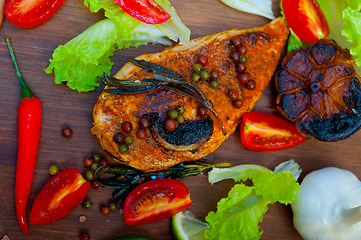 Image showing wood fired hoven cooked chicken breast on wood board