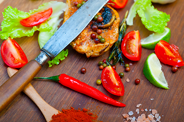 Image showing wood fired hoven cooked chicken breast on wood board