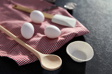 Image showing eggs, flour, spoon, spatula, strainer and towel