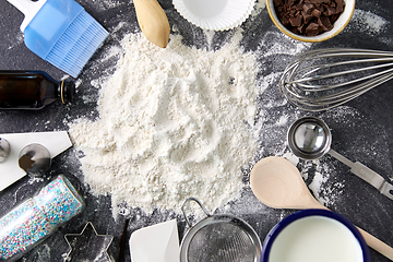 Image showing flour with baking and cooking ingredients on table