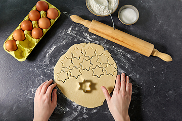 Image showing hands with shortcrust pastry dough and star mold