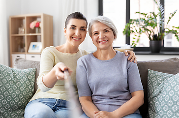 Image showing senior mother with daughter taking selfie at home