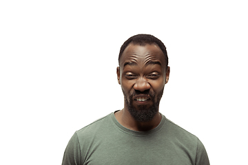 Image showing Young african-american man with funny, unusual popular emotions and gestures isolated on white studio background