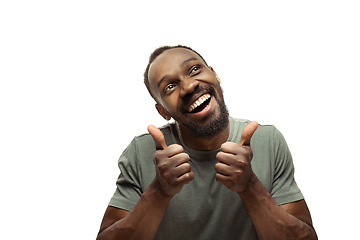 Image showing Young african-american man with funny, unusual popular emotions and gestures isolated on white studio background