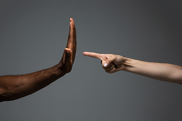 Image showing Racial tolerance. Respect social unity. African and caucasian hands gesturing isolated on gray studio background