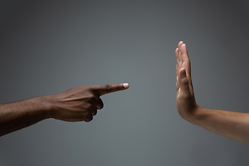 Image showing Racial tolerance. Respect social unity. African and caucasian hands gesturing isolated on gray studio background