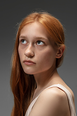 Image showing Portrait of beautiful redhead woman isolated on grey studio background. Concept of beauty, skin care, fashion and style