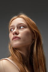 Image showing Portrait of beautiful redhead woman isolated on grey studio background. Concept of beauty, skin care, fashion and style