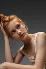 Image showing Portrait of beautiful redhead woman isolated on grey studio background. Concept of beauty, skin care, fashion and style