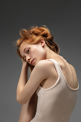 Image showing Portrait of beautiful redhead woman isolated on grey studio background. Concept of beauty, skin care, fashion and style