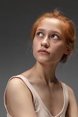 Image showing Portrait of beautiful redhead woman isolated on grey studio background. Concept of beauty, skin care, fashion and style