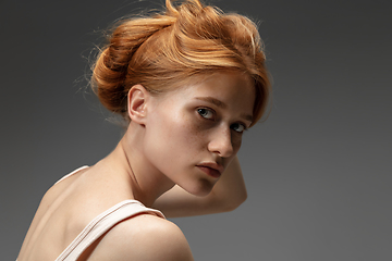 Image showing Portrait of beautiful redhead woman isolated on grey studio background. Concept of beauty, skin care, fashion and style