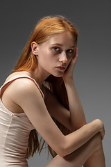 Image showing Portrait of beautiful redhead woman isolated on grey studio background. Concept of beauty, skin care, fashion and style