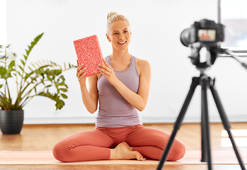 Image showing woman with camera streaming for yoga blog at home