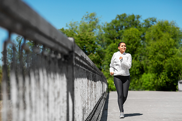 Image showing african american woman running outdoors