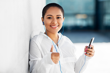 Image showing african american woman with earphones and phone