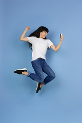 Image showing Portrait of young asian woman isolated on blue studio background