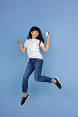 Image showing Portrait of young asian woman isolated on blue studio background